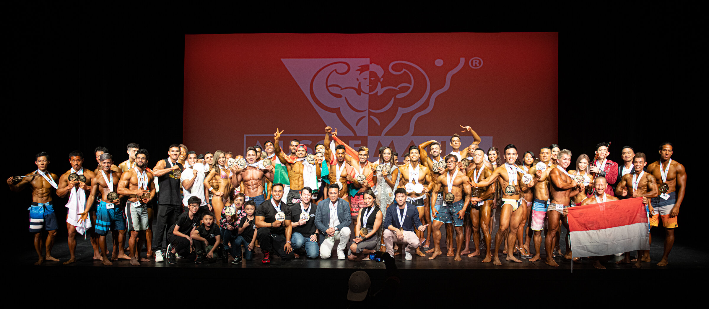 Competitors from Asia take a group photo during MuscleMania Asia Show at the Singapore Airline Theatre.