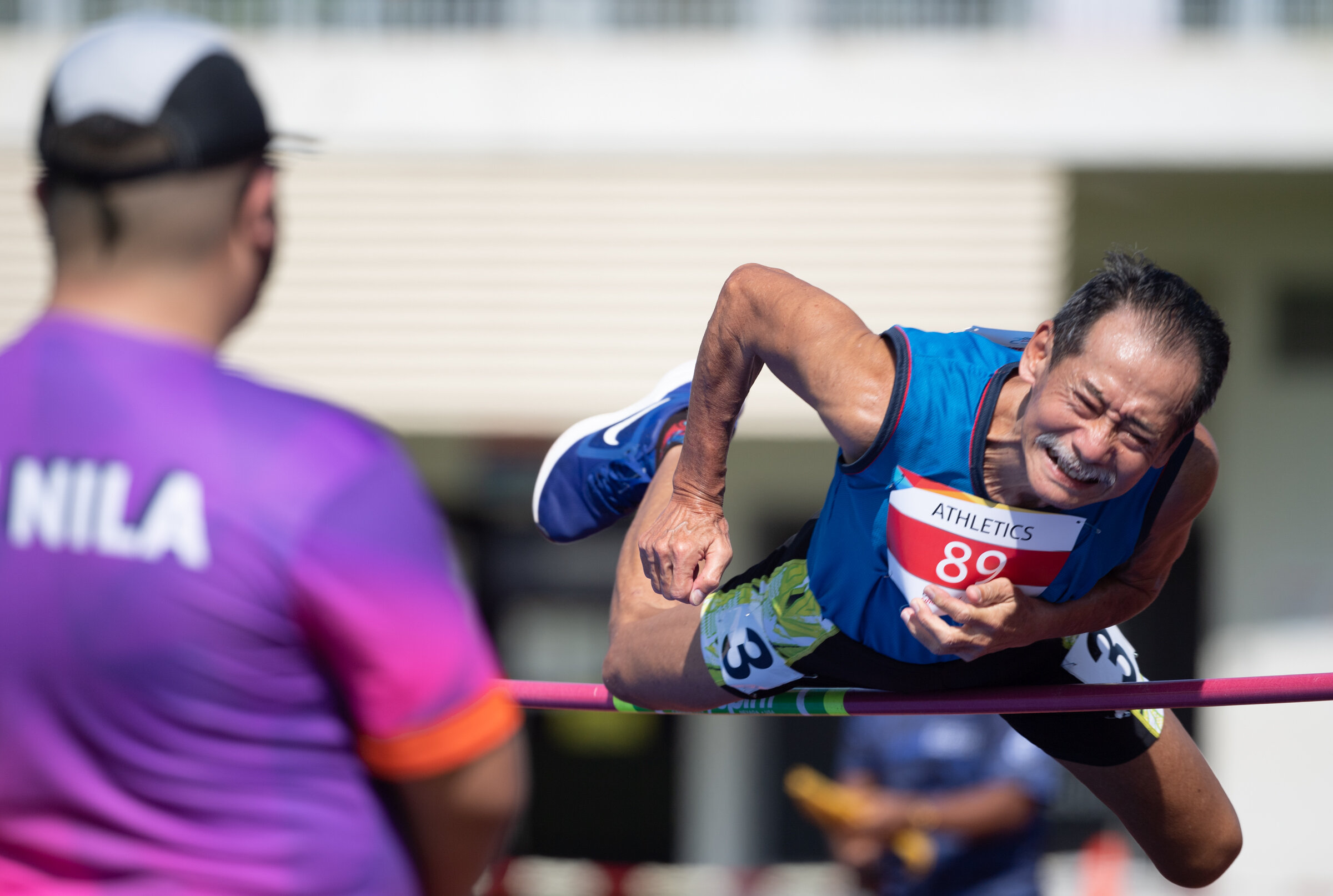 A masters athlete jumps over the high jump bar during the Singapore Open Track and Field Championships held at the Home of Athletics.