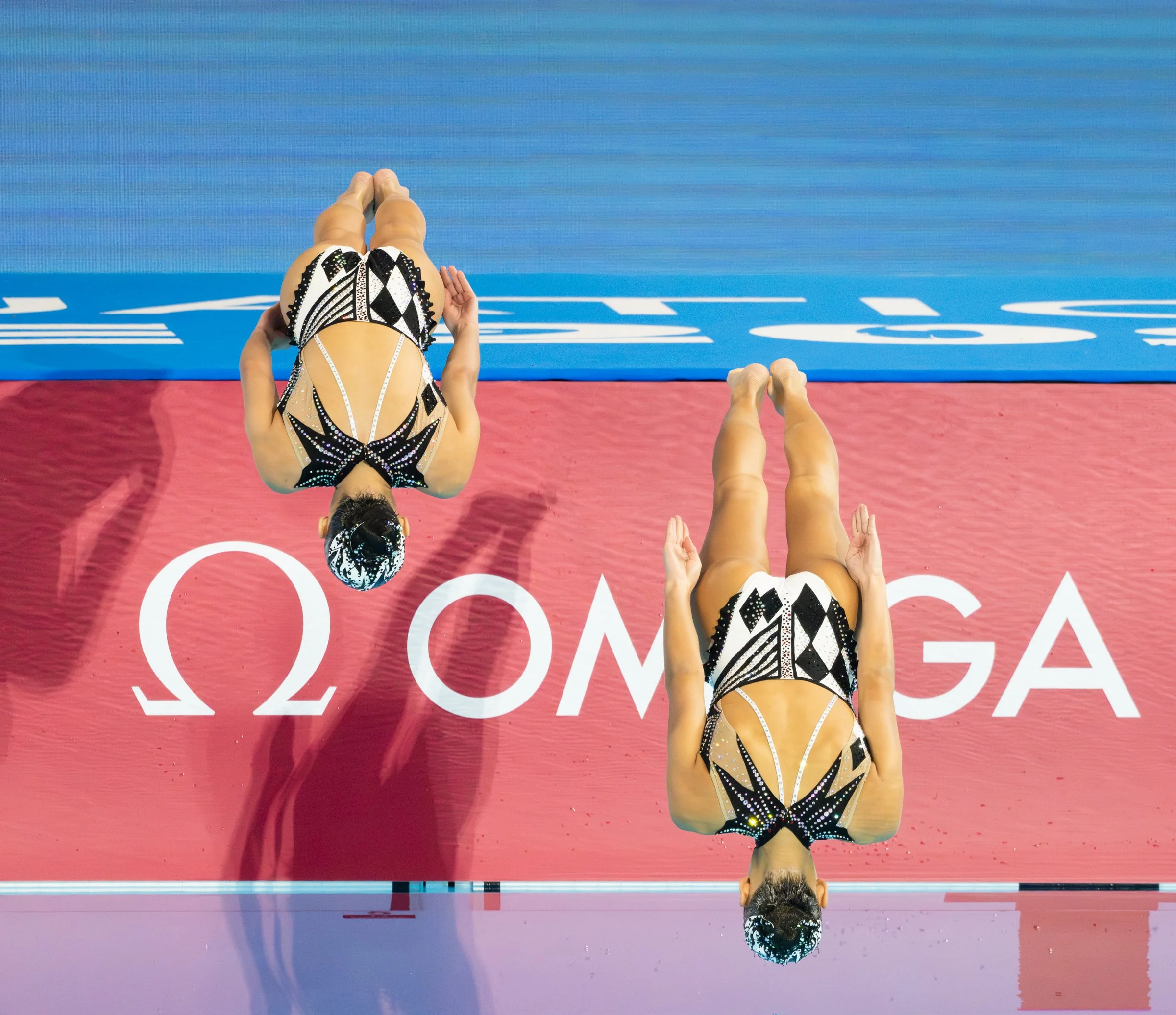 Uzbek Artistic swimmers in action during the Aquatics World Championships at the World Aquatics Championship Arena.