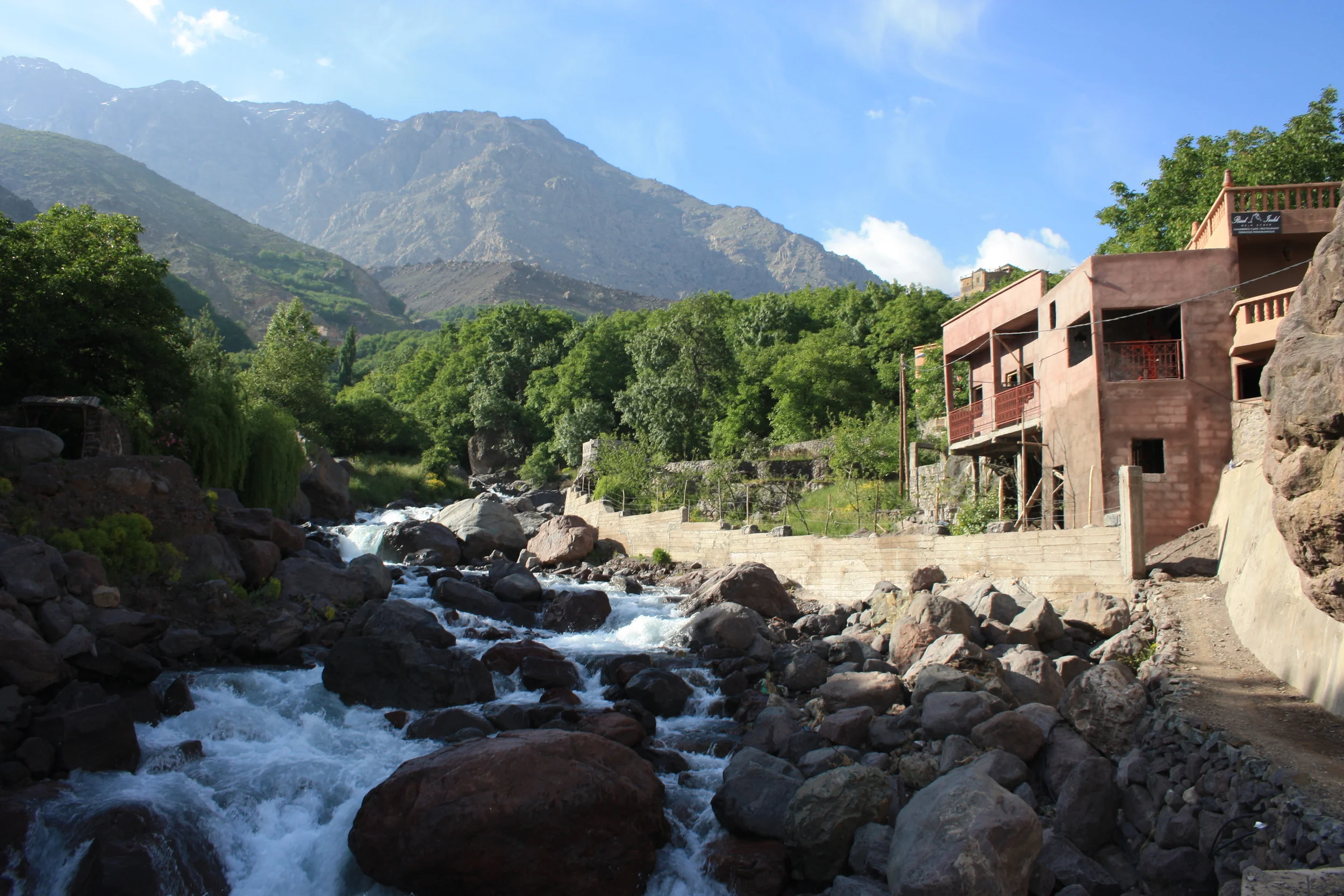 A waterfall cascades through the town of Imlil