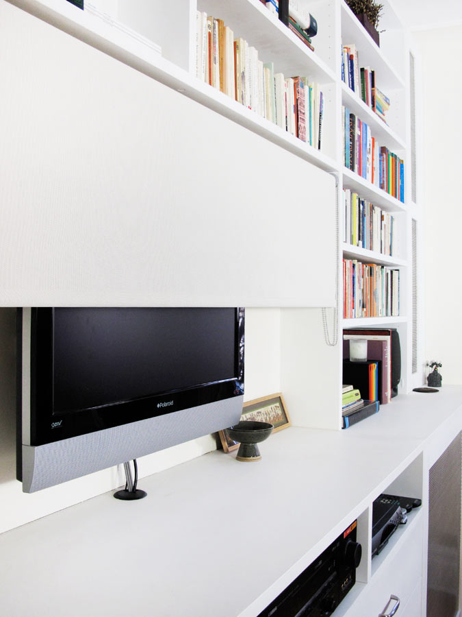 A custom-fitted screen hides the TV