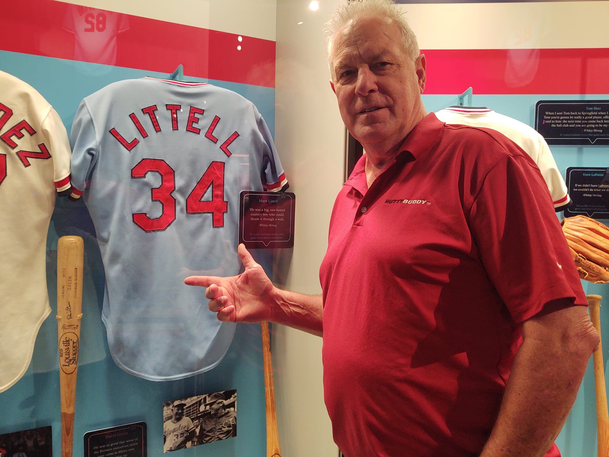 Mark pointing out his jersey on display at the 2022 reunion of the 1982 Cardinals championship team