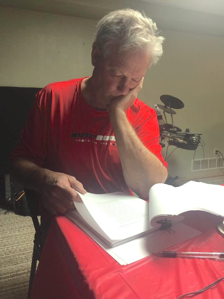 Mark reading manuscript of his first book, "On the Eighth Day, God Made Baseball"