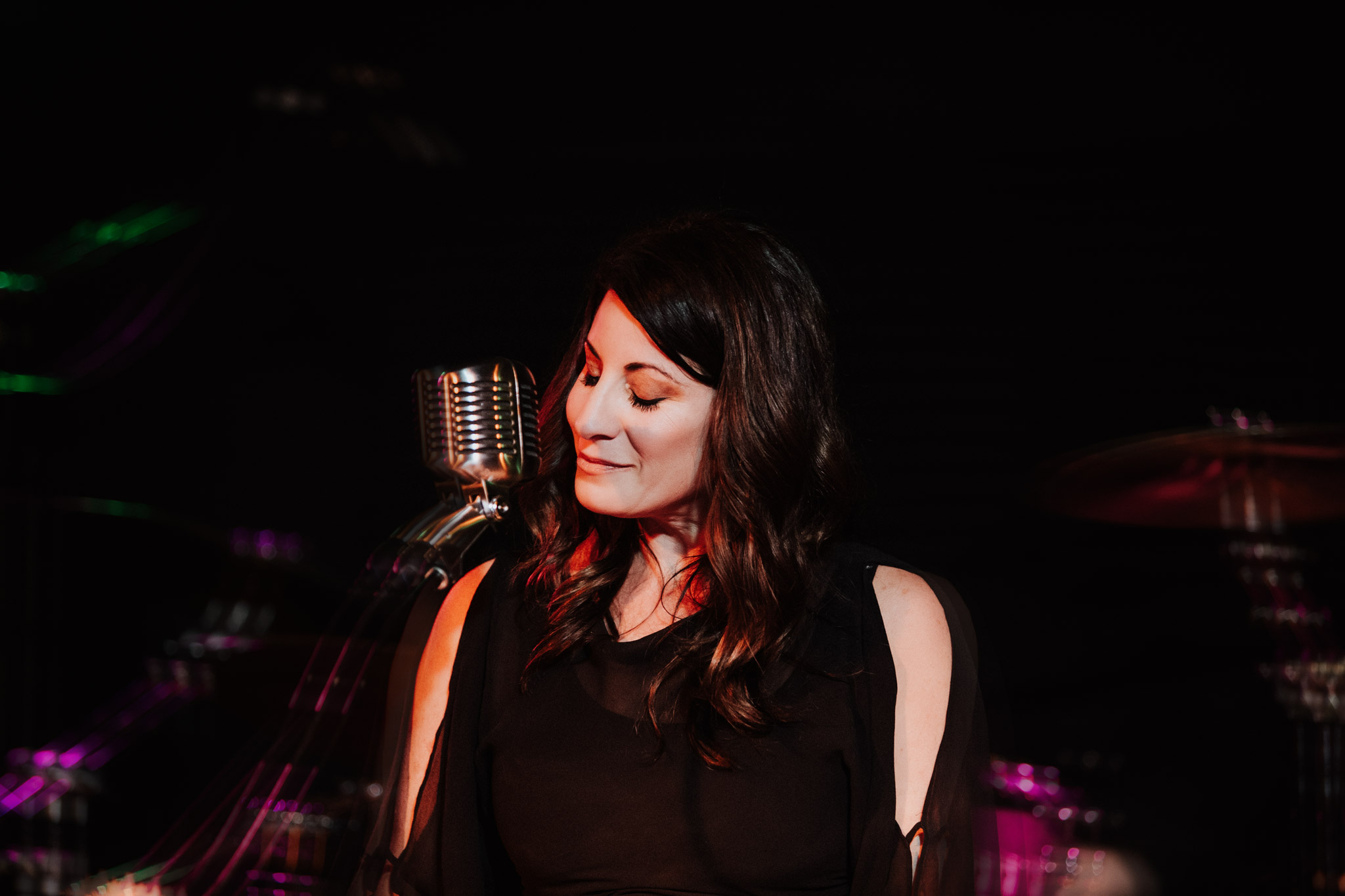 female keyboardist smiling eyes closed