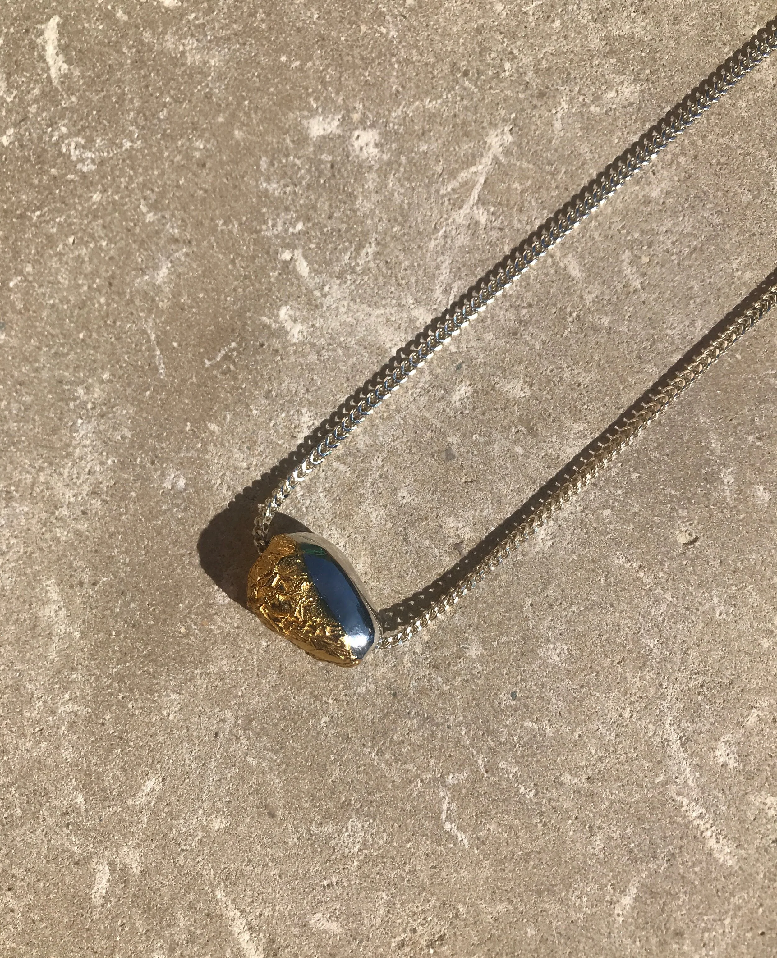 gold textured egg pendant, heavy silver chain