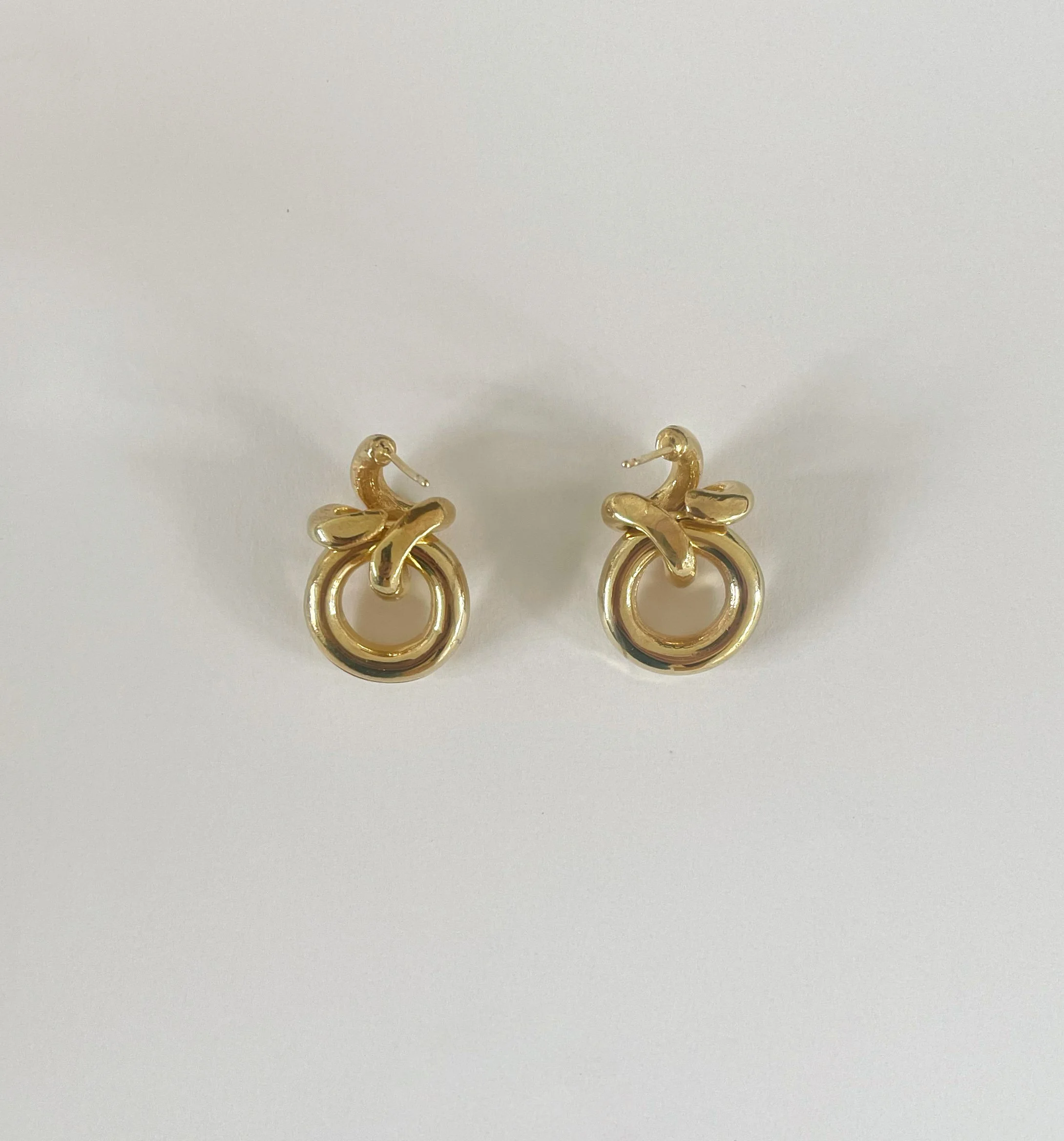 a pair of modern gold hoop earrings for pierced ears