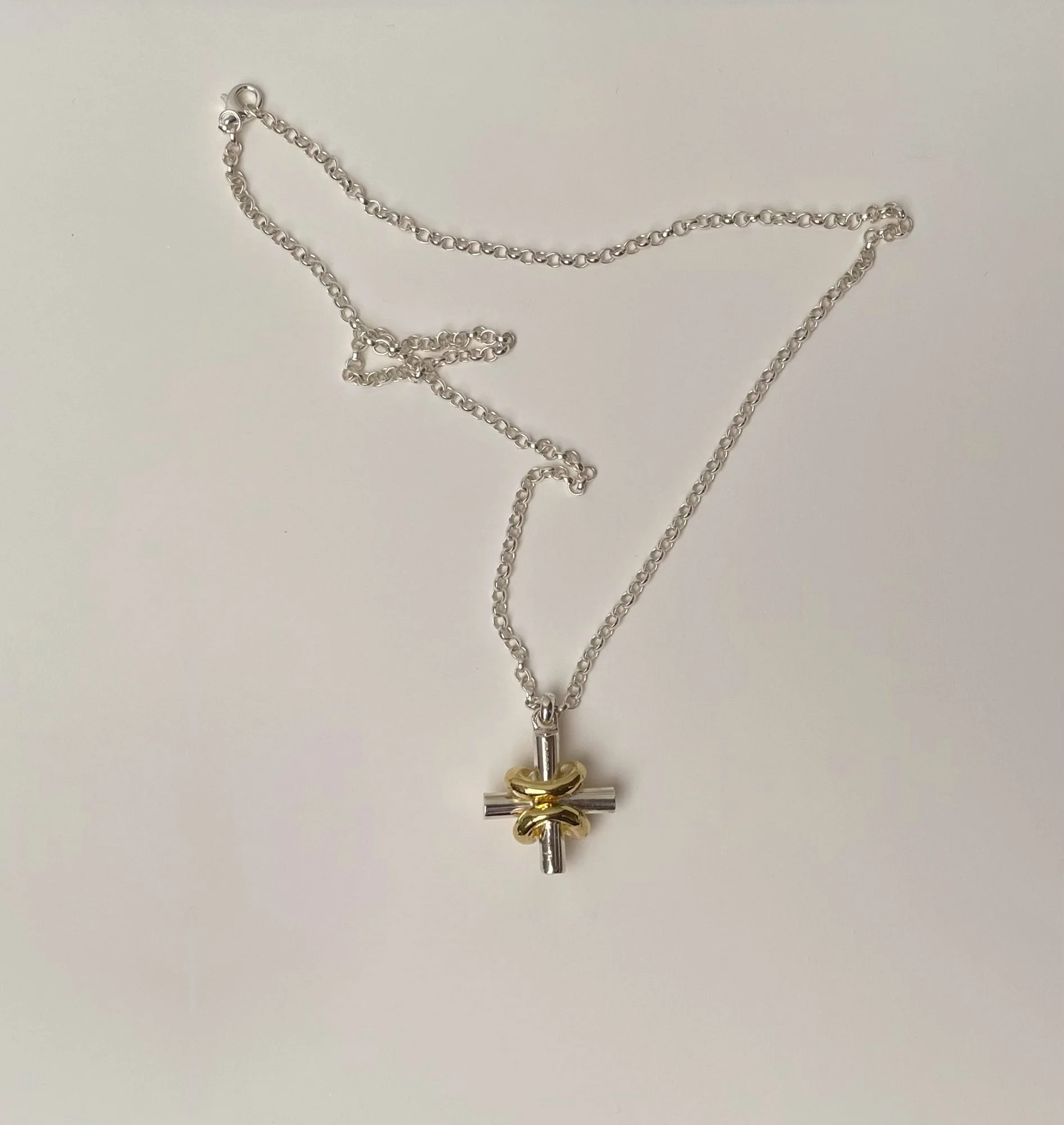 a gold and silver mix equal armed cross pendant