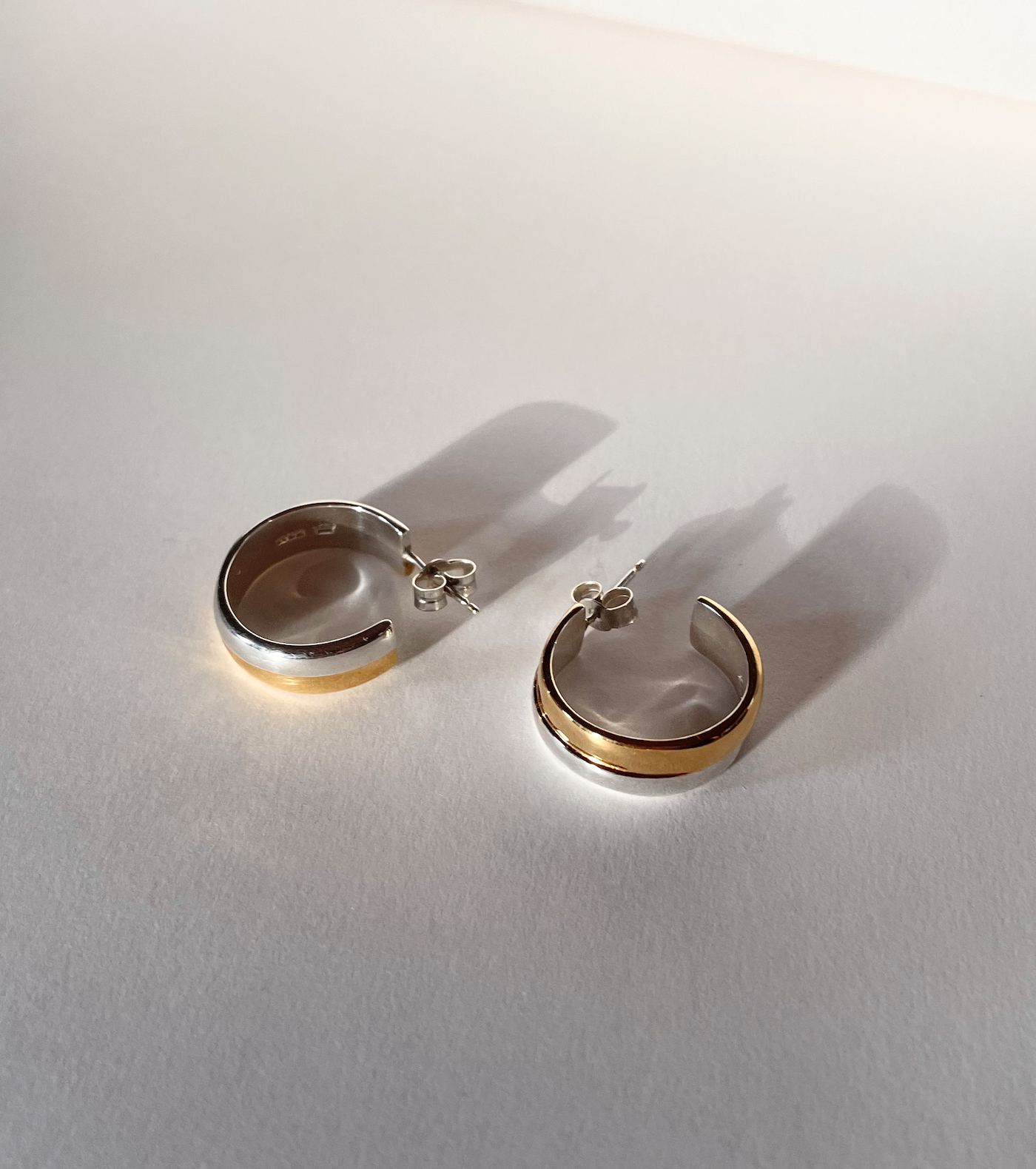 joan hooops silver gold mix earrings.png