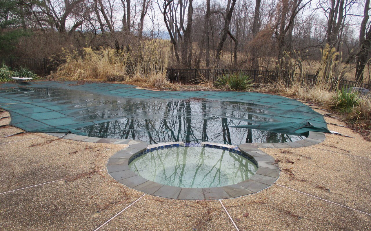  Here is a concrete swimming pool that is ready for a complete update. 