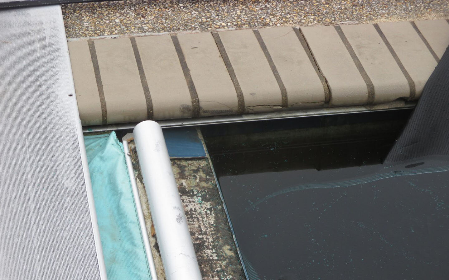  A closeup of the damaged coping and tile. 