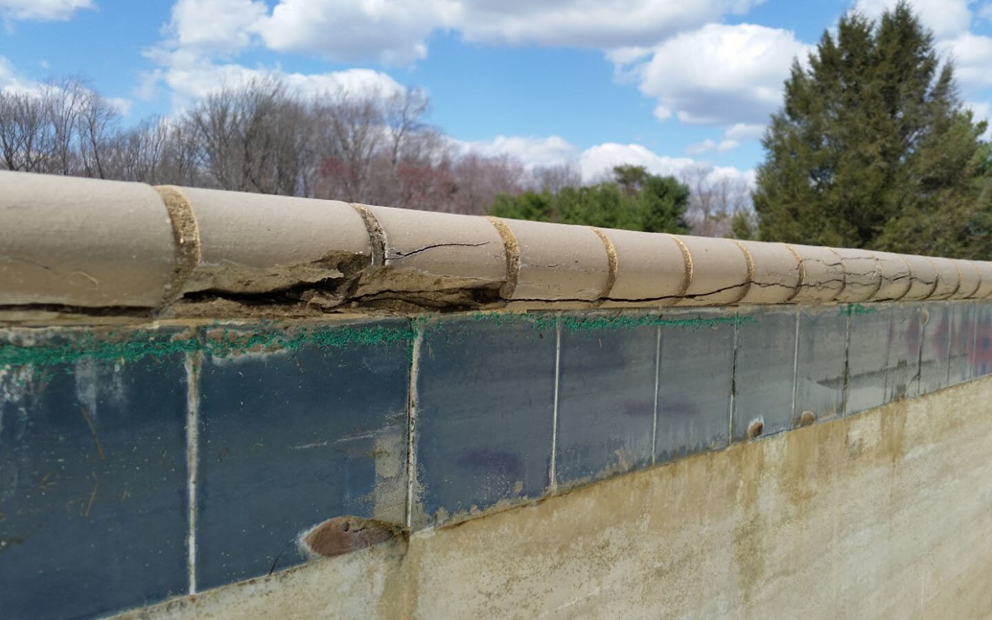  Again, overly high water levels coupled with freezing temperatures has damaged the tile in several locations evident by the chips in the tile line. 