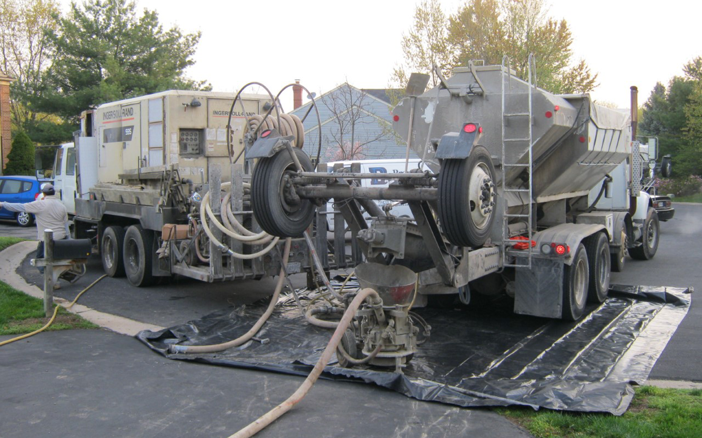  The gunite crew arrives to re-shoot the removed areas of the pool and to lock in the new plumbing fittings. Shown here is the batch truck and compressor truck. Gunite is the raw concrete material pushed through a hose dry, with water added at the no