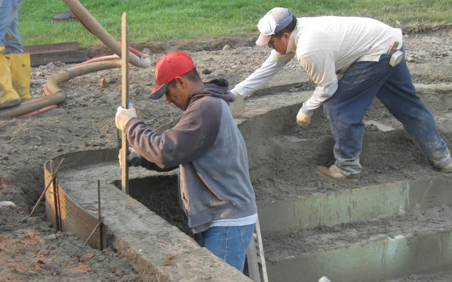  After the new concrete has been built up, it is worked into the desired shape of the pool &amp; step entry. 