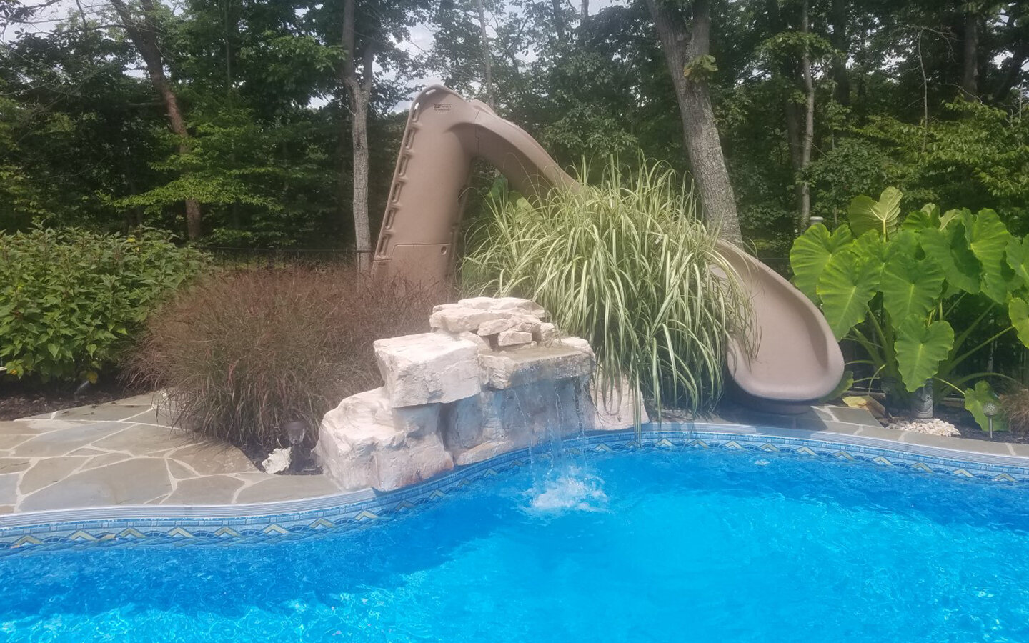  Featuring a decorative, family friendly slide and an artificial stone waterfall. 