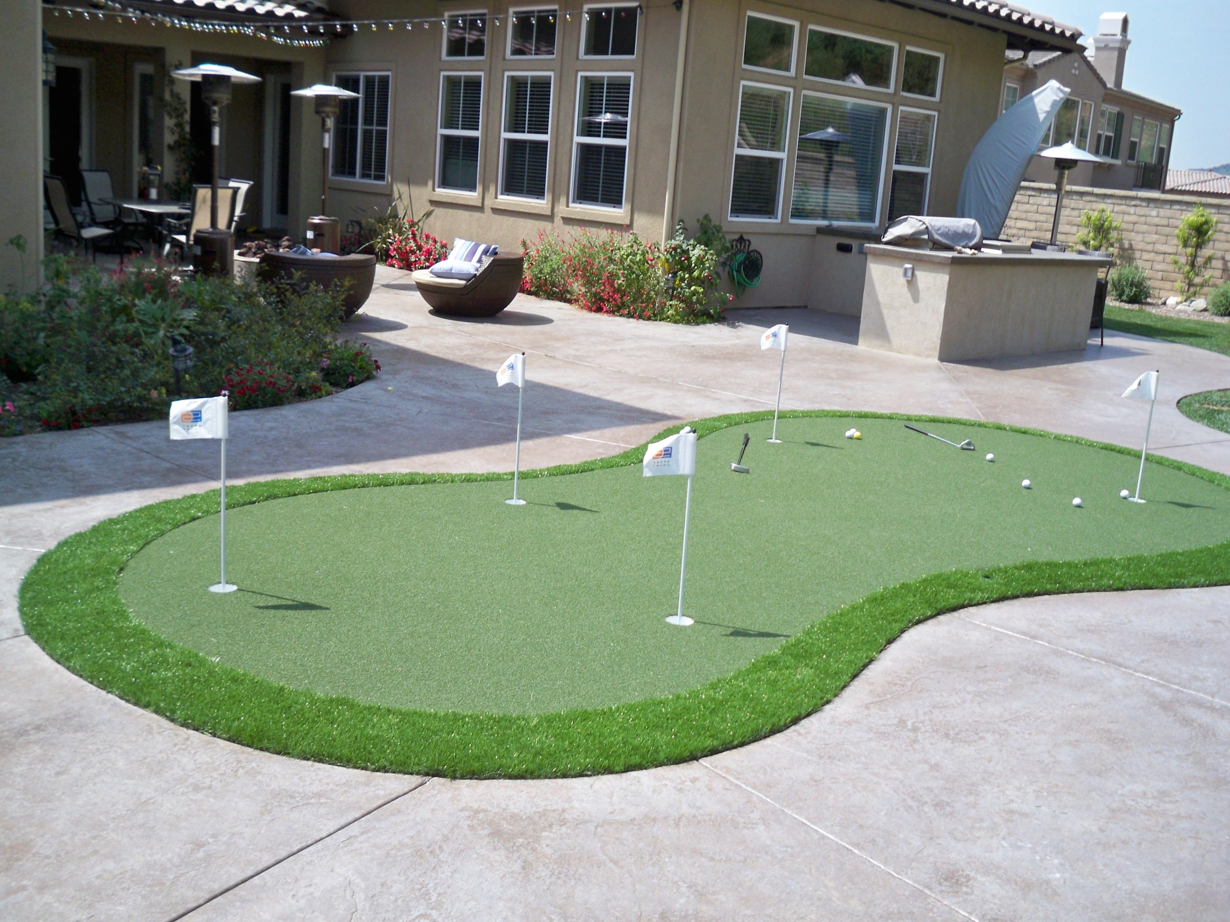 Synthetic grass by pavers