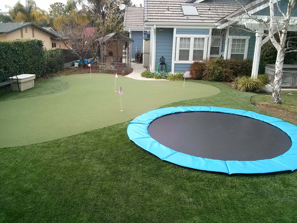 In ground trampoline with synthetic grass