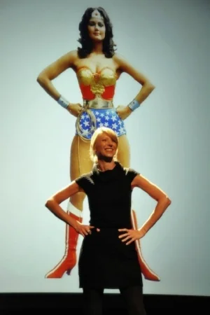 Professor Amy Cuddy demonstrating an expansive posture during a talk.