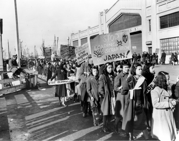 A group of Chinese demonstrators at the waterfront in San Francisco carrying signs protesting the sale of scrap iron to Japan. December 20, 1938. Photographer unknown. Gelatin silver print. Collection of Oakland Museum of California.