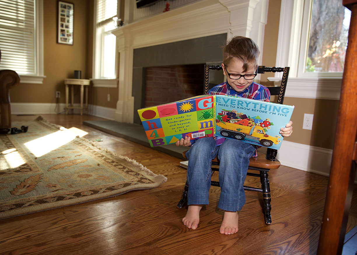 sweet boy in rocking chair reading everything to know before im five.jpg