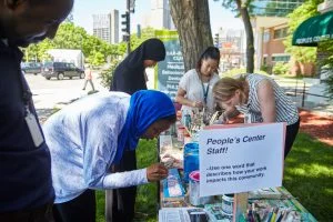 The Mobile Sign Shop by artist Peter Haakon Thompson engages People’s Center staff members in making signs for a lobby installation that reflects the values of the clinic. Photo courtesy of Uche Iroegbu.