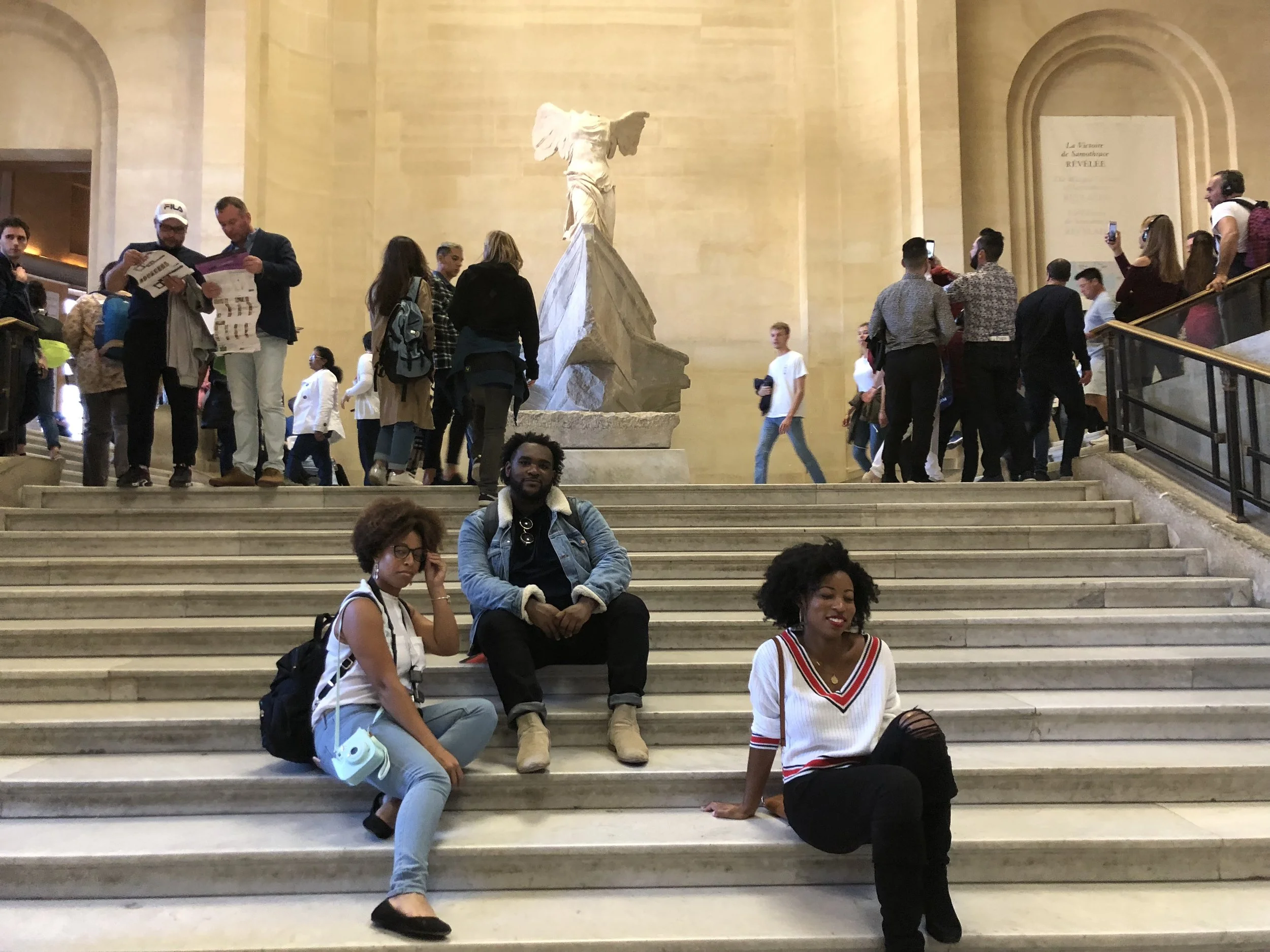 All you have to do to get a staircase to yourself in the Louvre is be black and sit down