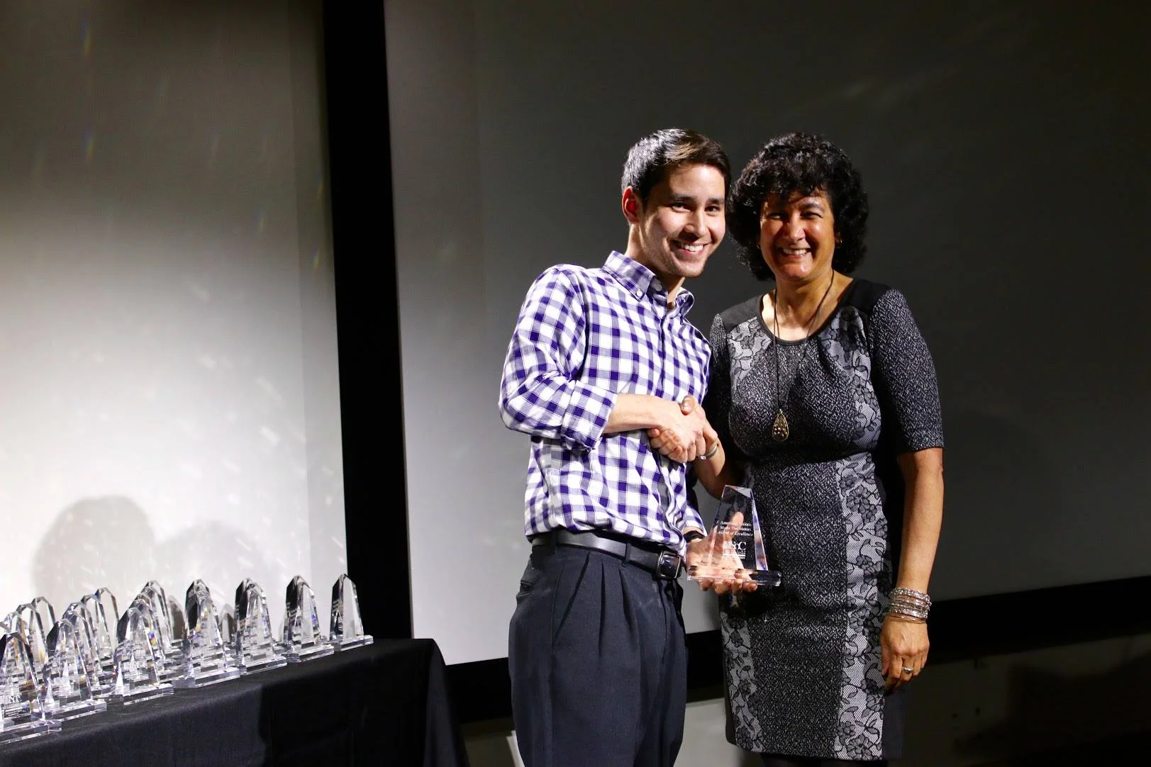 Editor Adam Lee accepts the award for Best Editing at the 2016 Visions Awards at American University.