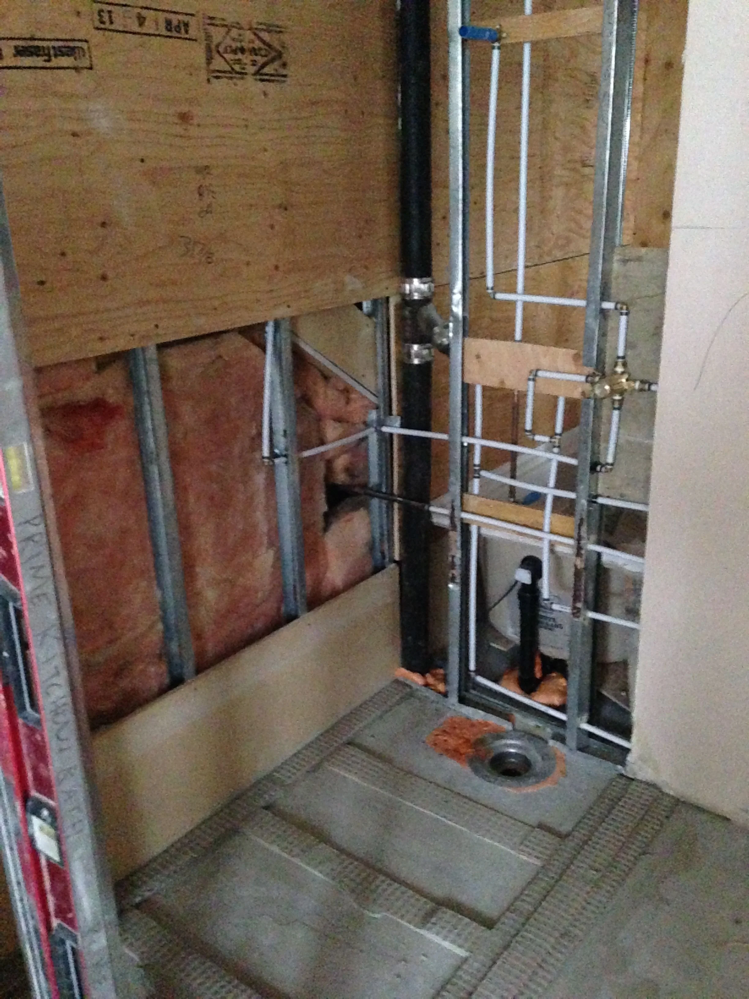 The amazing roll-in shower/wet room. That drain (and the toilet) wasn't moved a single inch because of the concrete slab and space planning the bathroom with the existing was challenging but it will work out brilliantly for the client.