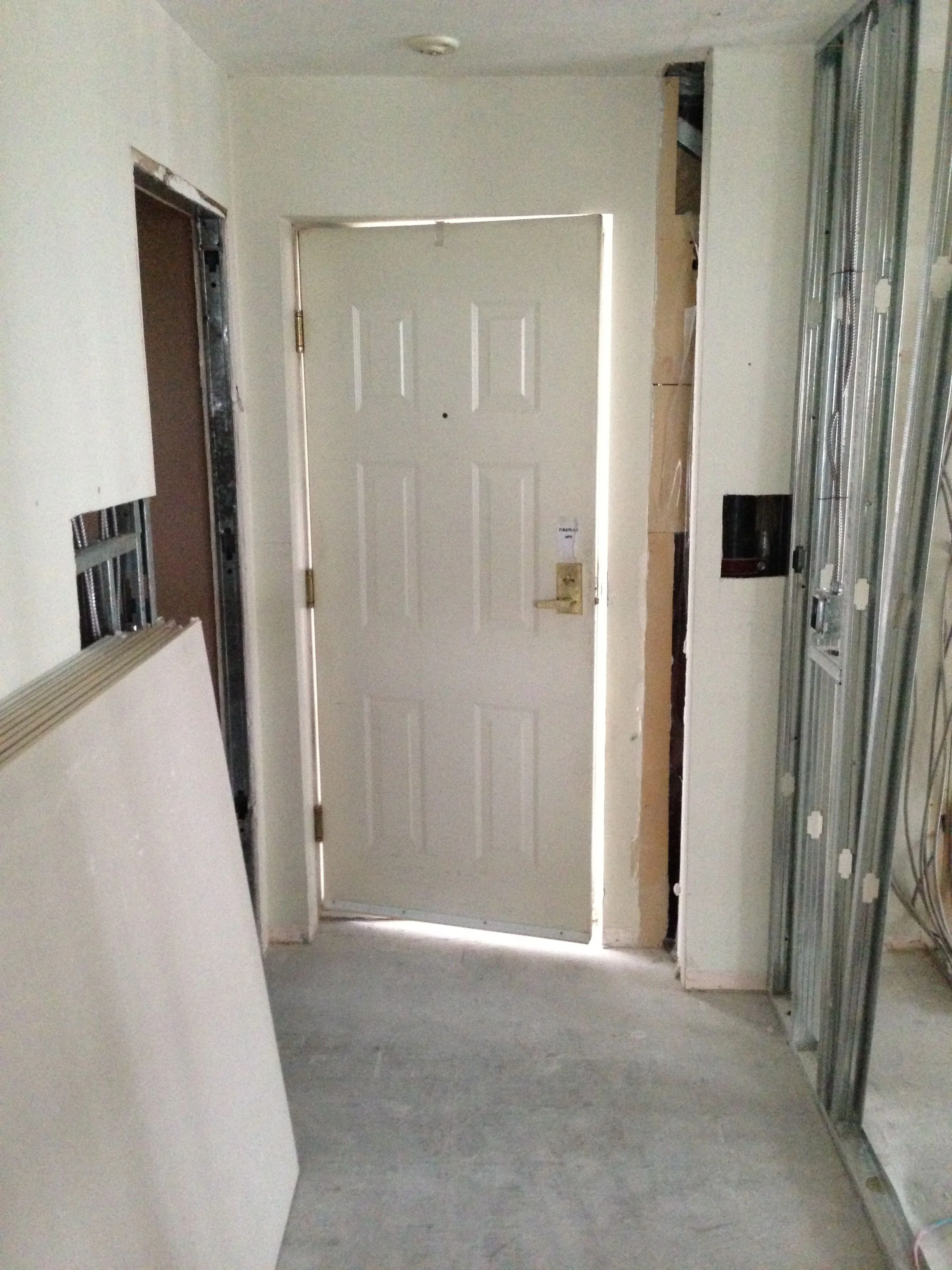 The front entry has been widened, with yet another structural/mechanical surprise behind the walls. Lighting switches needed to be relocated.