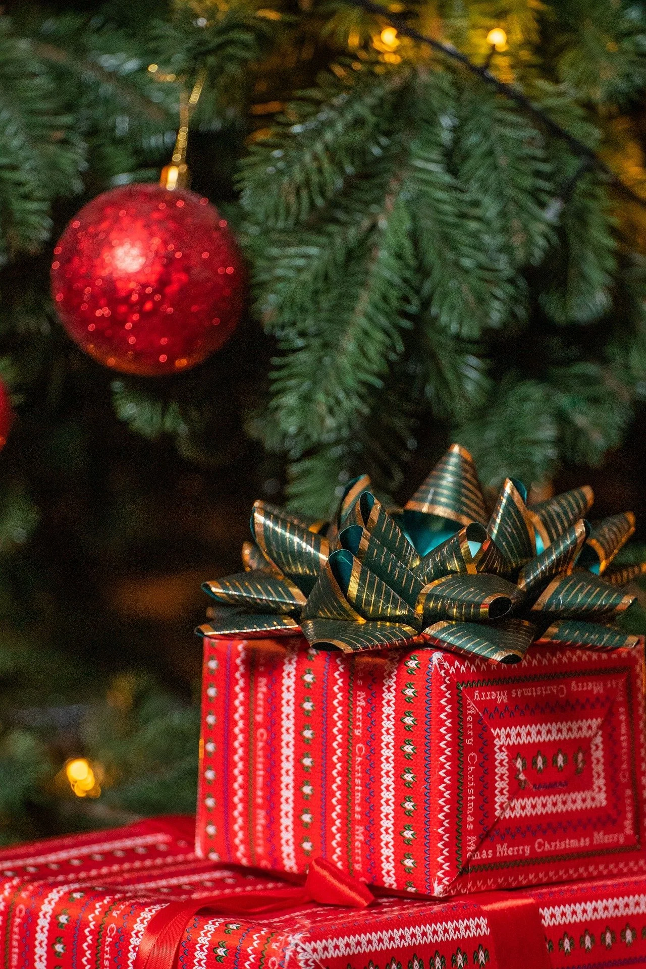 Close-up of gifts, bauble and Christmas tree