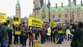 Nicholas participating in a protest to free Raif Badawi while articling at Amnesty Int’l.