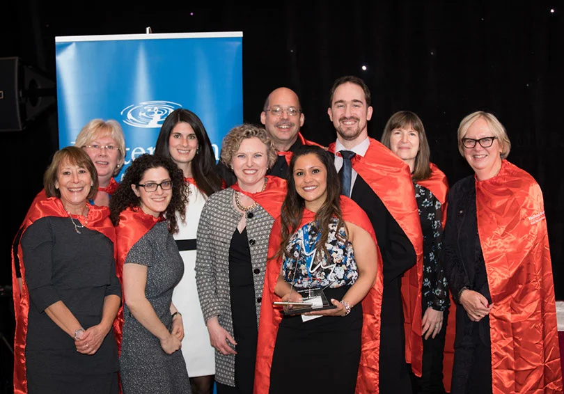 Julia and her team wearing capes at the inaugural year of their annual fundraiser Capes for Kids