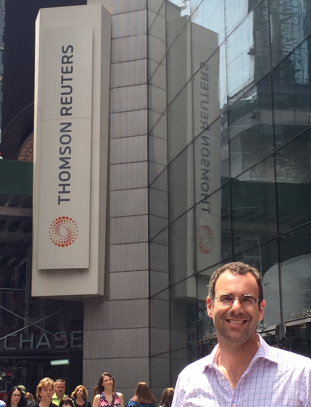Neil standing in front of the Times Squares location of Thomson Reuters