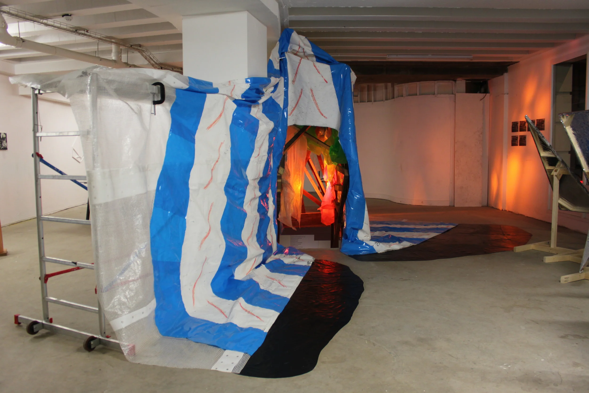 Circus Curtains , scaffold tower, scaffold sheeting, rubble sacks, rubber flooring, various plastics, light gels, Par 64 lights x 3, clamps, emulsion paint, marker pen, 330cm x 510cm x 300cm, 2014