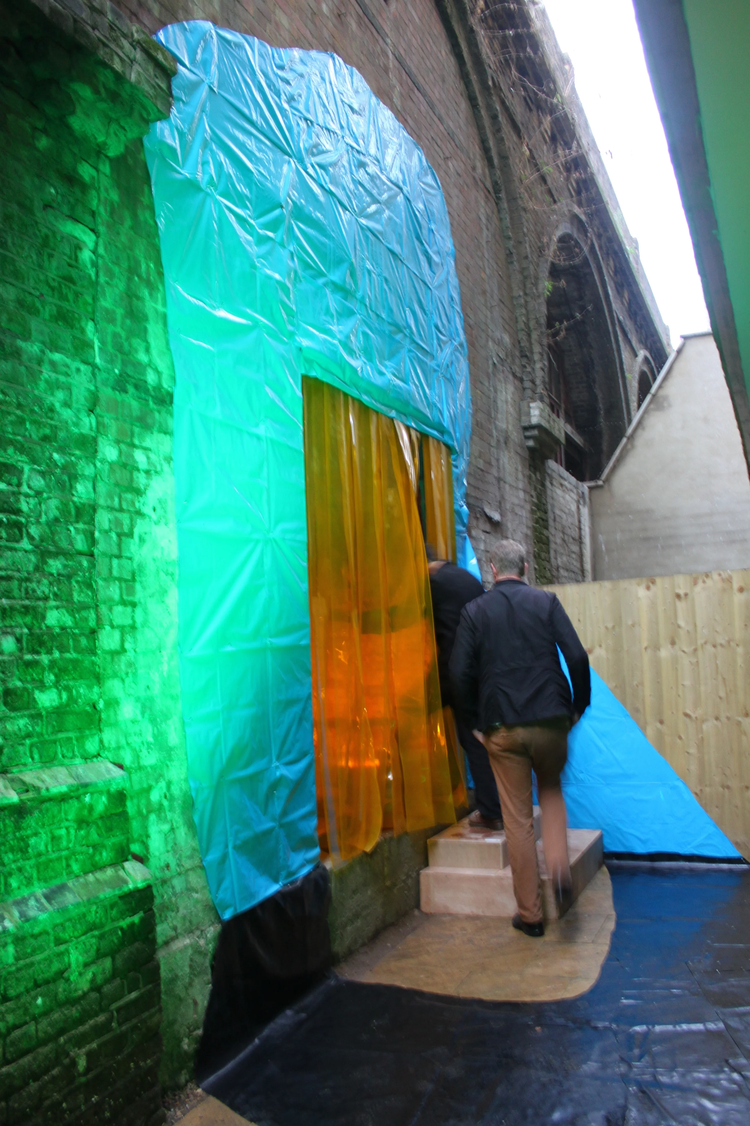 Portal (rail) , rubble sacks, rubber flooring, pvc strips, metal railing, Par 64 lights x 2, light gels, 440cm x 280cm x 240cm, 2013