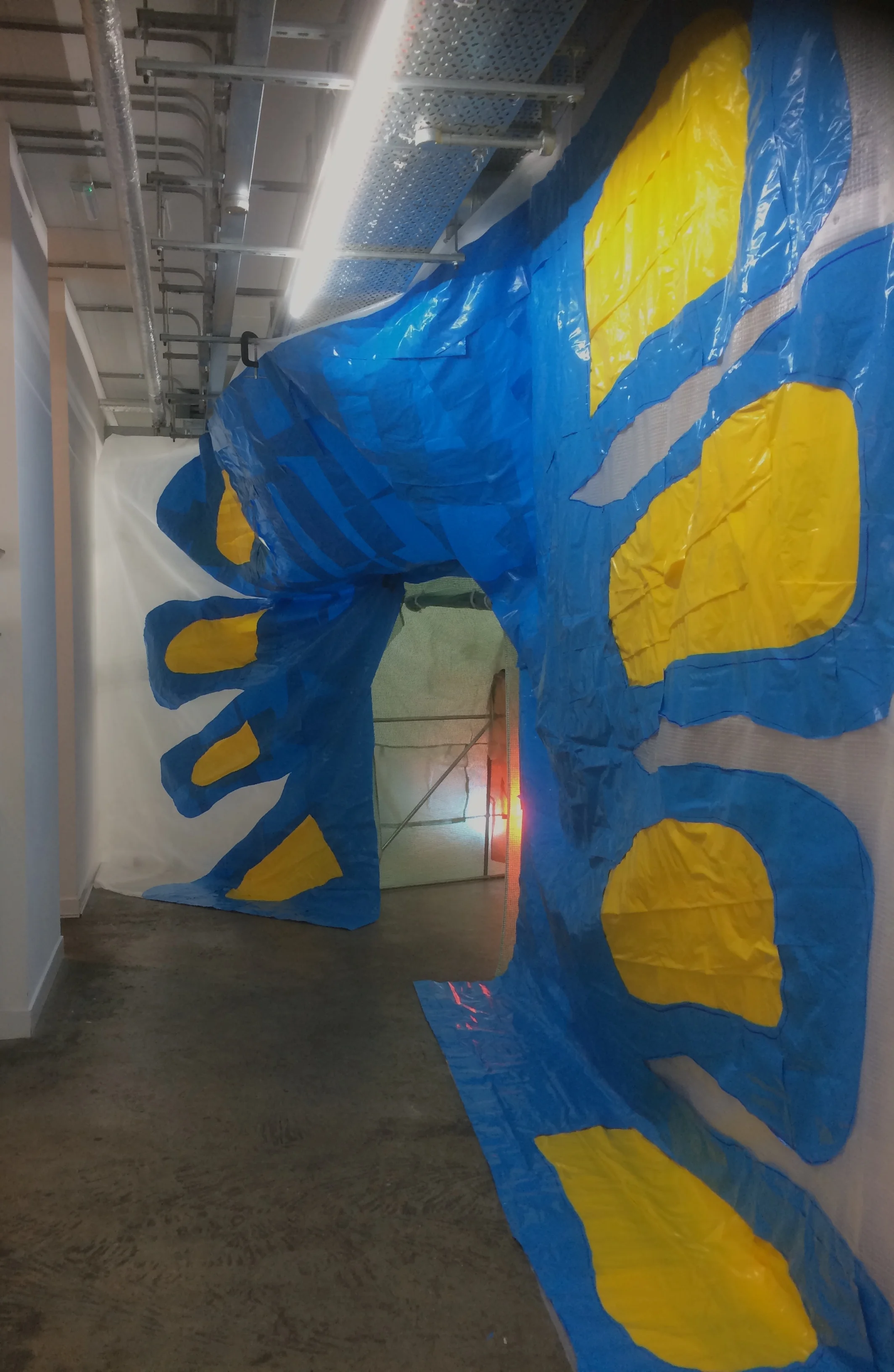 Portal/Tunnel (For HM - Vence), rubble sacks, marker pen, scaffold sheeting, clamps, clips, cable-ties, polytunnel with cover, various plastics, lightgels, Par 64 lights x 3, 330cm x 640cm x 410cm, 2016