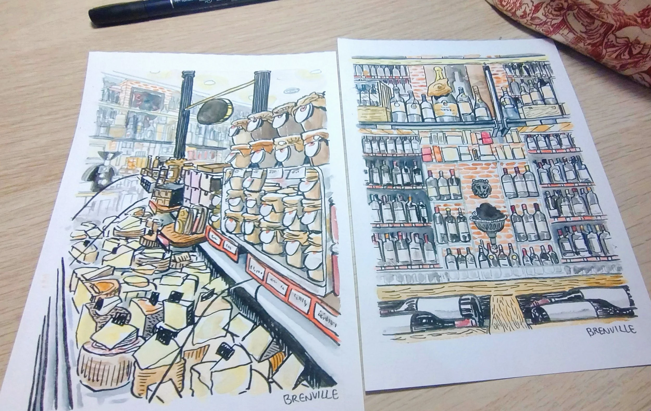 Ilustraciones de una tienda con diferentes productos, incluyendo queso, embutidos y botellas de licor o vino, en un estilo artístico con líneas negras y color. La firma 'Brenville' aparece en la esquina inferior derecha de ambas ilustraciones.
