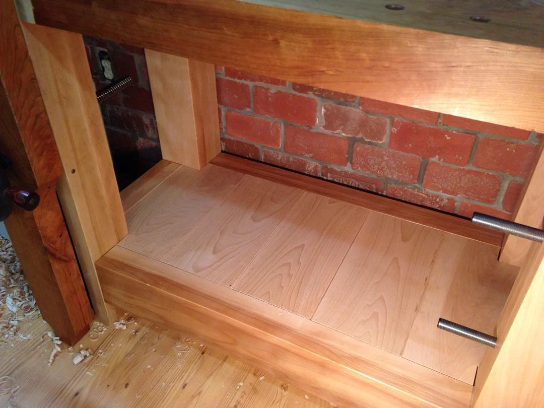 I’ve recently moved to a shelf that sits flush with the top of the stretchers on my benches. It’s way easier to use my brush to clean shavings and whatnot off. I used to set the shelf down an inch or so but it was always full of debris. I suppose the trough approach might be useful on a ship, but unnecessary on dry land where the bench doesn’t move! Hahahahaha. These tongue and grooved shelf boards will receive some shellac later tonight… #condortails #madeinusa #madeinmichigan #Benchcrafted #woodshop #workshop #woodwork #handmade #cherry #beech #workbench #roubo #tenon #dovetail #legvise #wagonwheel #woodworking #mcmfurniture #lienielsen #whiteoak http://ift.tt/1WI5Y34