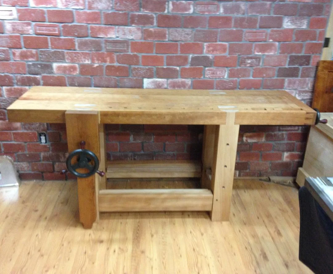 Just a quick shot of my new workbench in place. Getting this bad boy down a flight of stairs on my own with my ribs still on the mend wasn’t fun!
Only things still left to do are finish the white oak drawbore pins, mill shelf boards and add a tool rack to the rear side. Should be done in a few days and I will update with much higher quality pics at that time… #condortails #madeinusa #madeinmichigan #Benchcrafted #woodshop #workshop #woodwork #handmade #cherry #beech #workbench #roubo #tenon #dovetail #legvise #wagonwheel #woodworking #mcmfurniture #lienielsen #whiteoak http://ift.tt/1MweTyQ