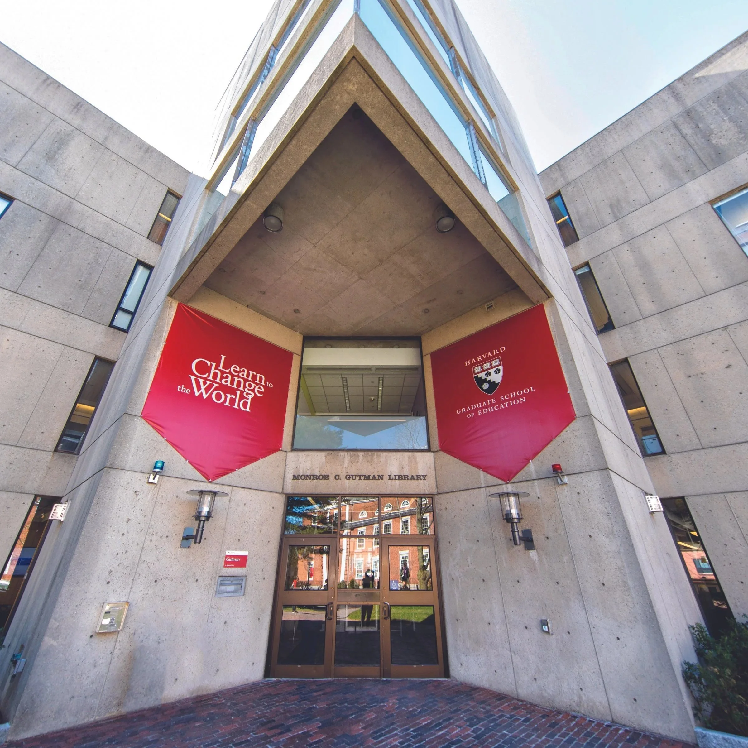 Large brutalist style building with red banners