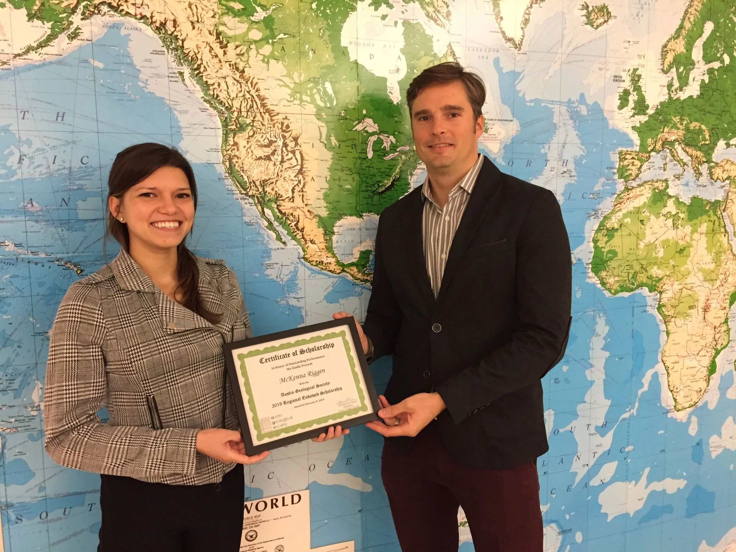  McKenna Riggen (left) accepts the award from Christian Dohse. 