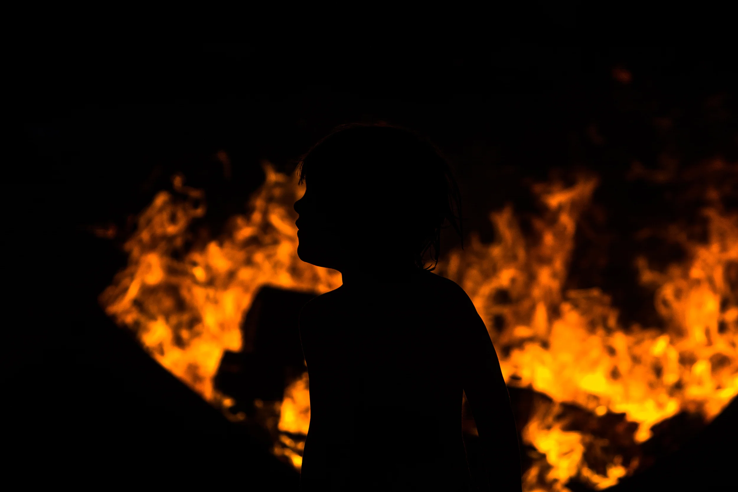 18 boy laying infront of beach bonfire in caribbean.jpg