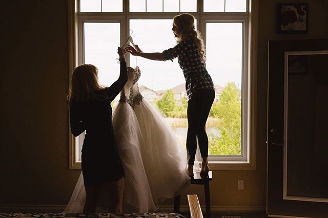 When the bride won't let the preggo photographer stand on the stool to hang the dress. Thanks Emily 😘😘😘
.
.
.
.
.
@allurebridals  @jamielynn.hair @shannonledgermua .
#yeg #yegweddings #yegbride #yegweddingphotographer #edmonton #edmontonphotograph