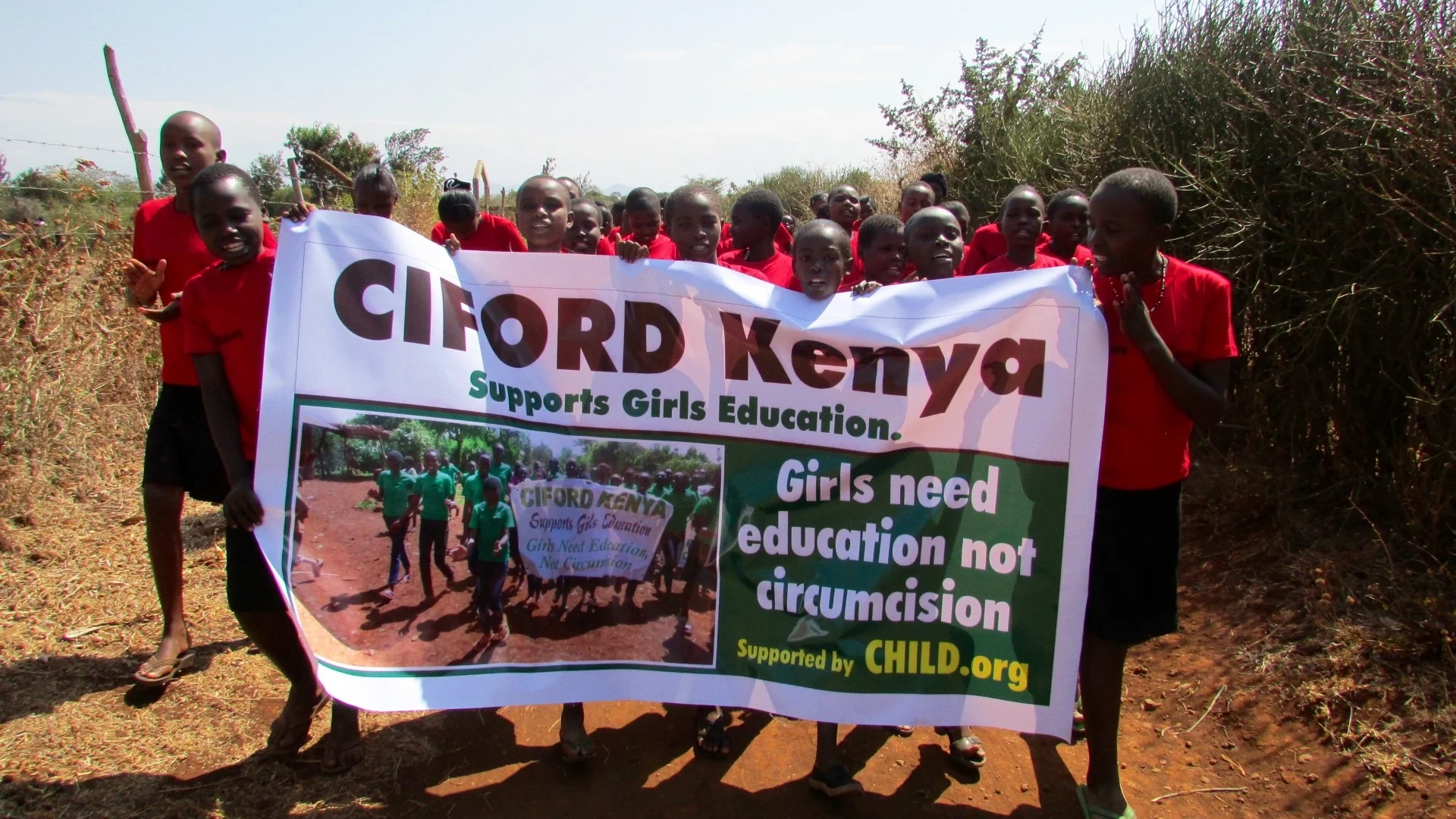 The initiates proudly parade through the street with the CIFORD banner 