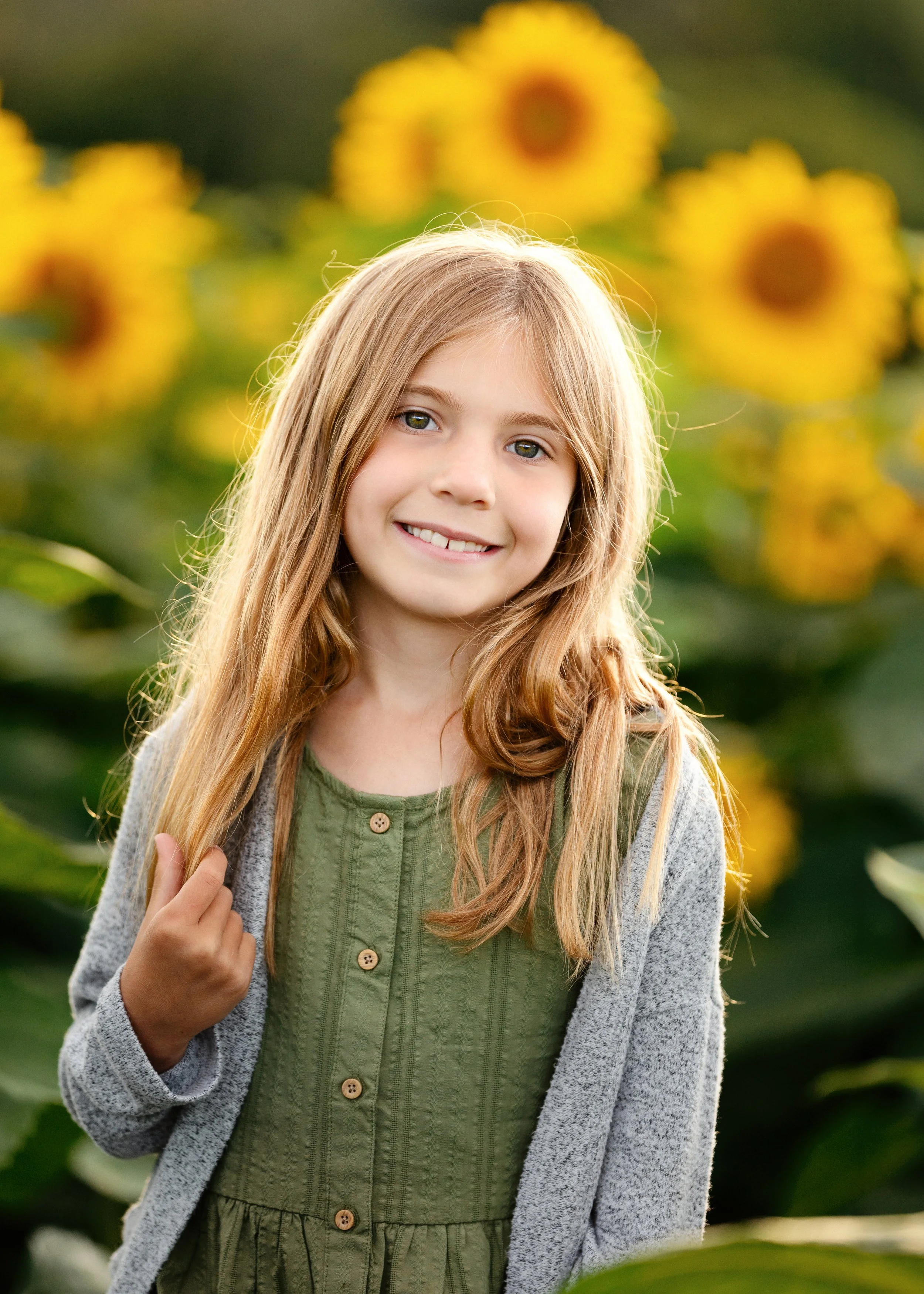 Young girl standing in a sunflower field in Rochester, NY