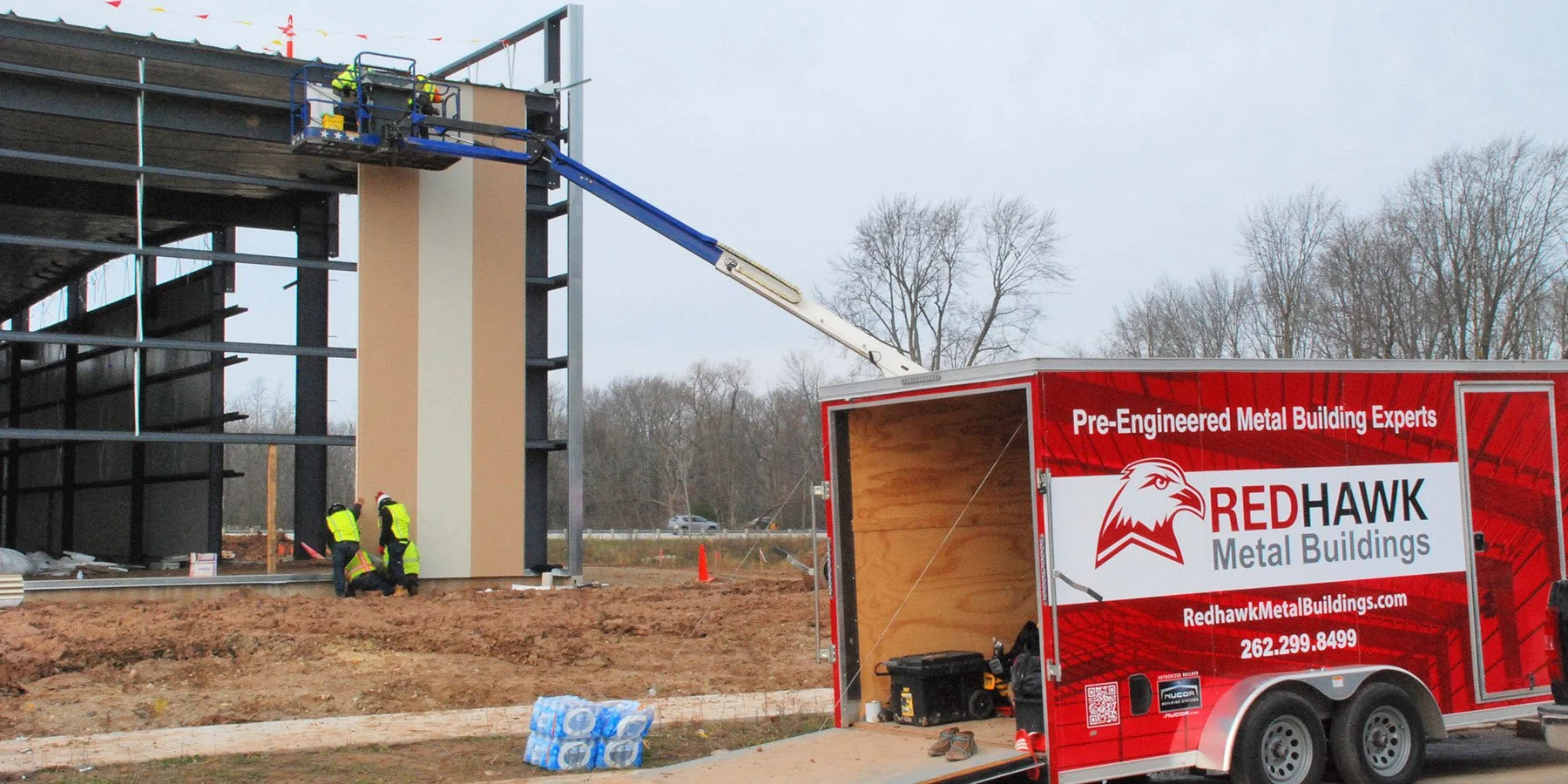Installing insulated steel panels on a steel building by Redhawk Metal Buildings