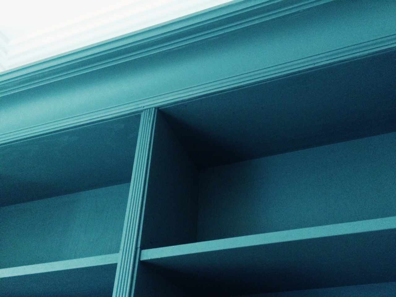 Lightweight coving stuck to the top of the bookcases is an easy and convincing way to pimp up the joined bookshelves. I would never have known these were four Ikea bookcases stuck together if I hadn't been told!