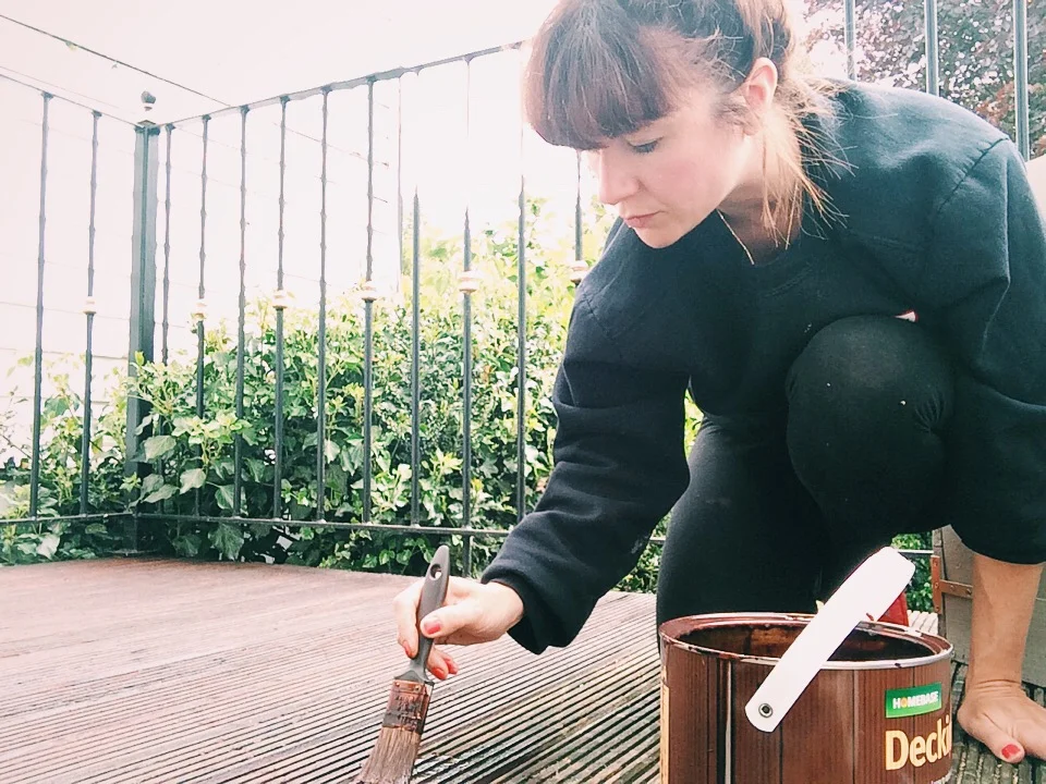 Here's me painting the decking in Homebase Decking stain in Teak...