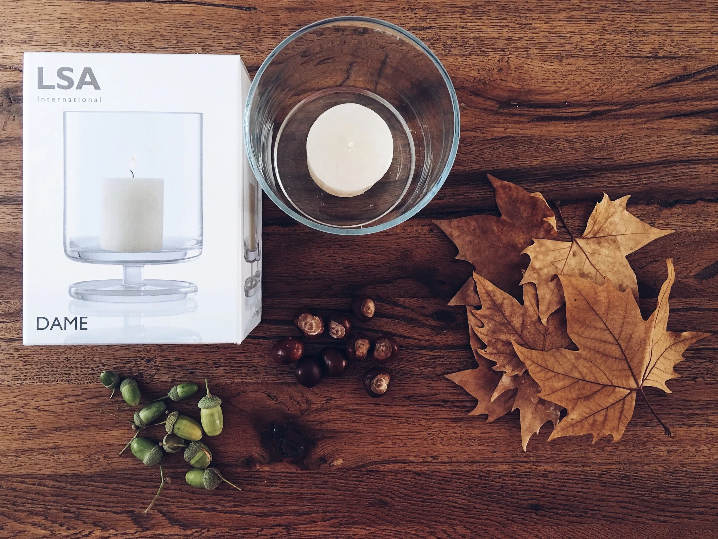 This is the 20.5cm DAME storm lantern by LSA International. Conkers, leaves and acorns were all foraged locally.