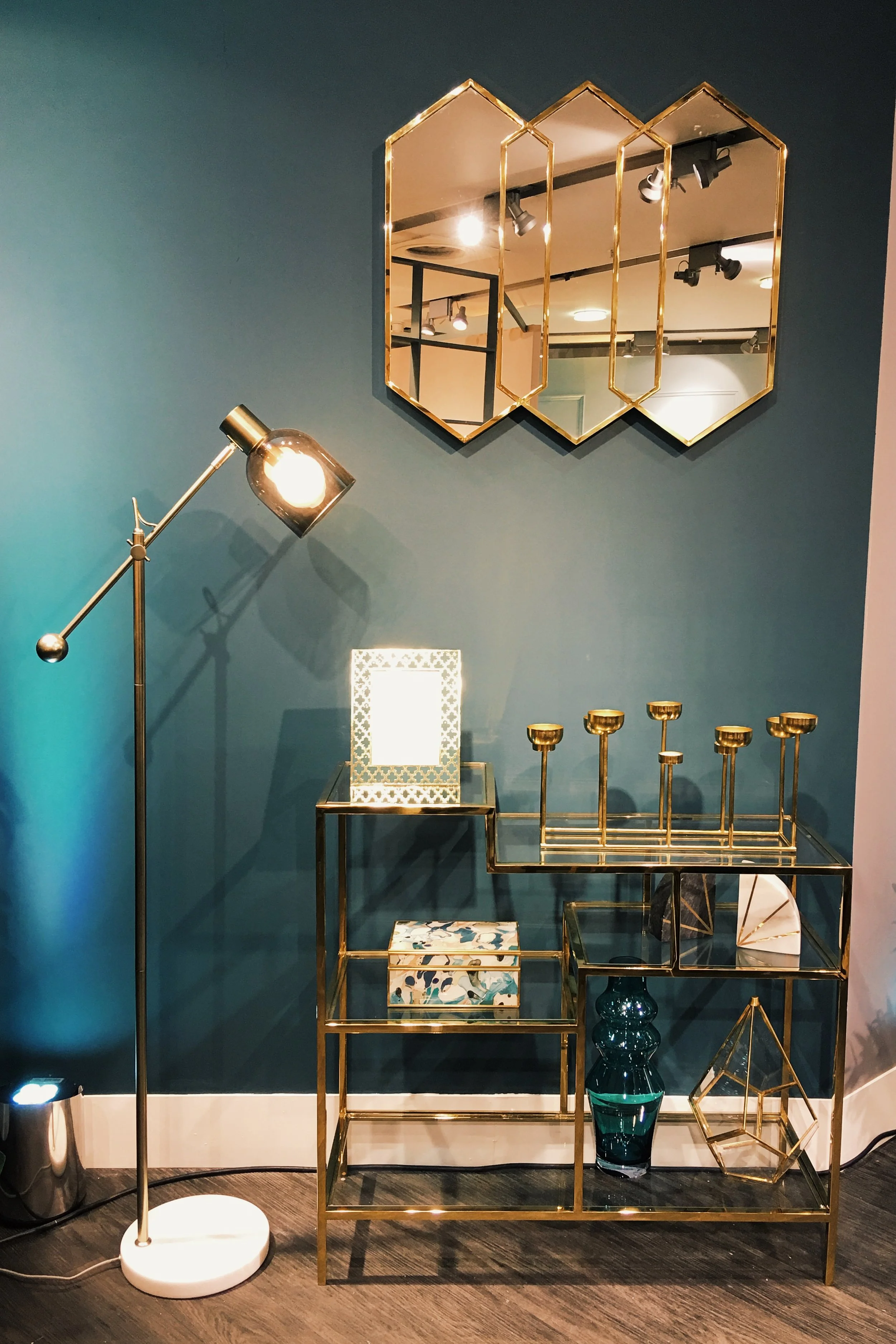 Conran Caleb Task Floor Lamp, £149. Barclay Shelving, £399. Triple Geo Mirror, £149. Multi-tea Light Holder, £49.50. Conran Marble Book Ends, £29.50 for the set. Aria Trinket box, £29.50. Gold Triangular Hurricane, £29.50. Conran Tall Vase, £29.50. Photo frame TBC. All M&S.