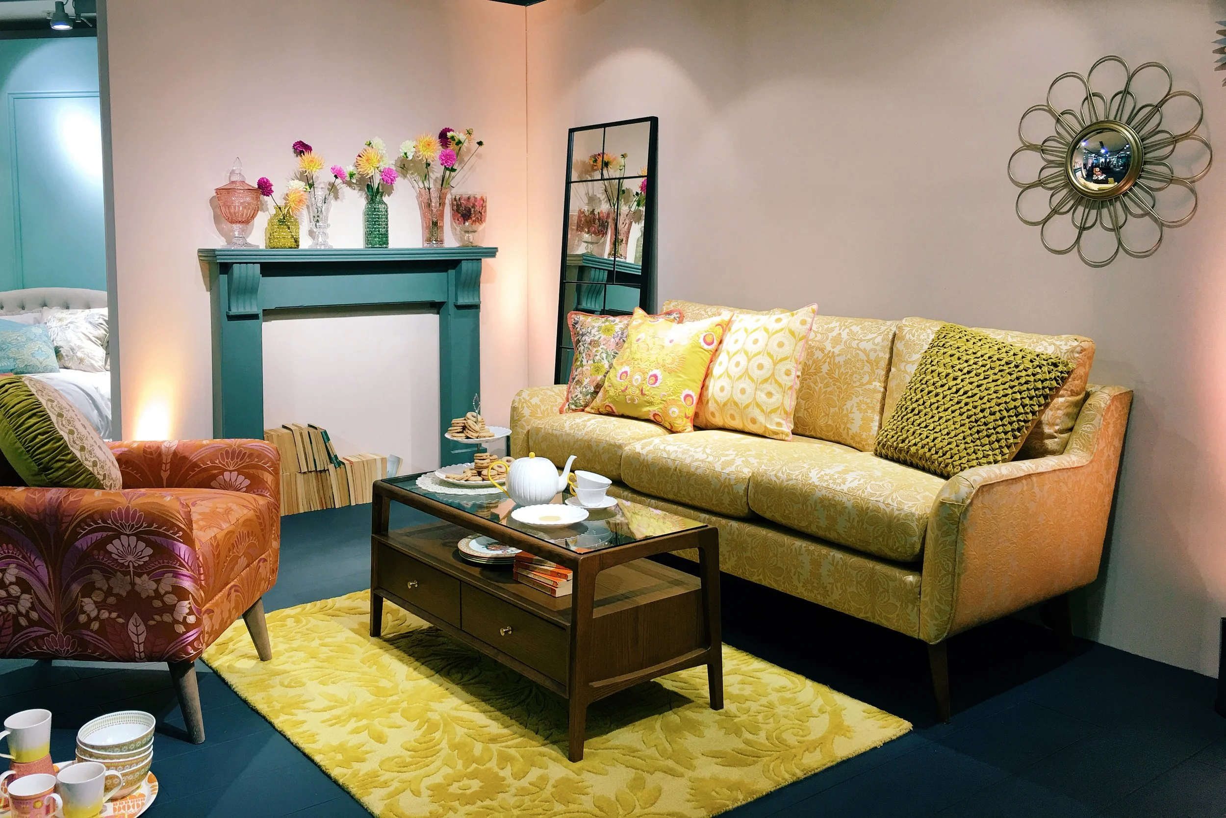 The 70's inspired 'Marigold' collection by M&S. Medium sofa in Meroni Medallion Yellow, £1099. Jolie Chair in Baylie Damask Burnt Orange, £449. Hayward Coffee Table, £349. Sunflower Mirror, £59. Pressed glass vases, from a selection, £12-£25.